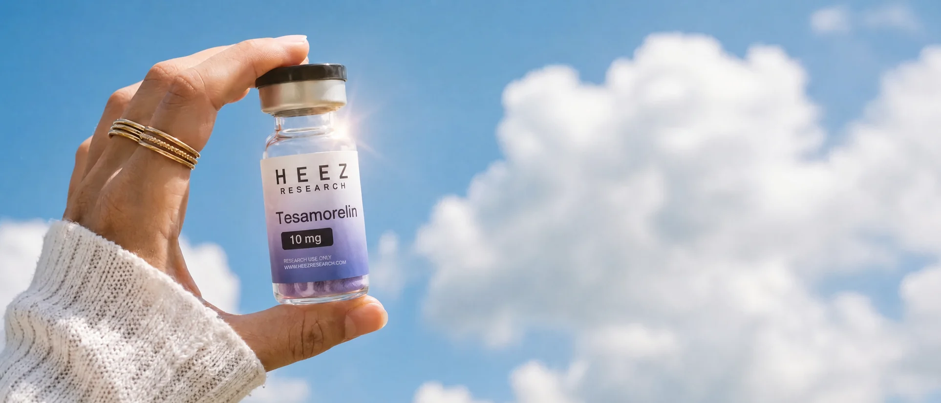 HEEZ Research tesamorelin 10 mg research vial held against a blue sky